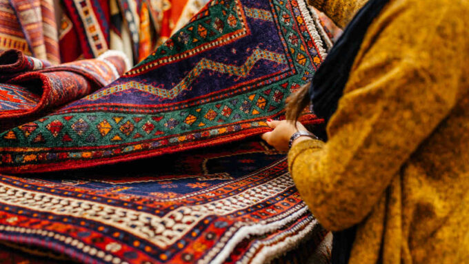 women looking at oriental rugs
